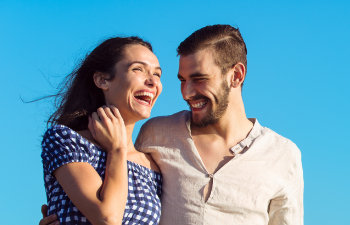 A happy young couple with a perfect smiles.