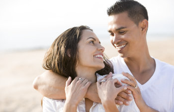 A happy young couple with a perfect smiles.