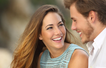 A happy young couple with a perfect smiles.