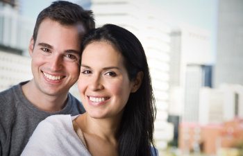 A happy middle-aged couple with a perfect smiles.