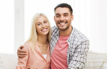 A happy young couple with a perfect smiles.