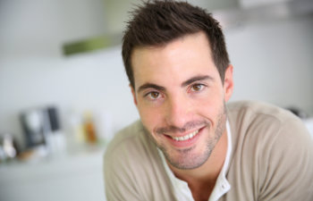 A happy young man with a perfect smile.