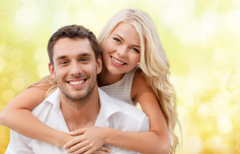 A happy young couple with a perfect smiles.