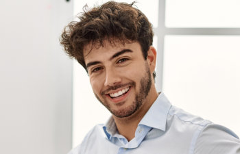 A happy young man with a perfect smile.