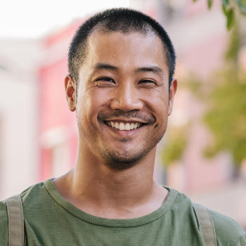 A cheerful middle-aged Asian man with a perfect smile.