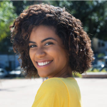 A cheerful young Afro-American woman with a perfect smile.