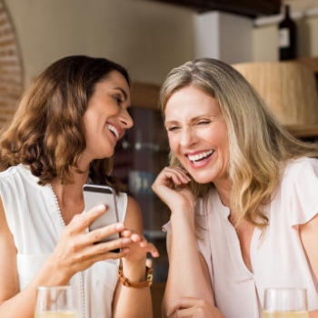 Cheerful mature women chatting in a restaurant.