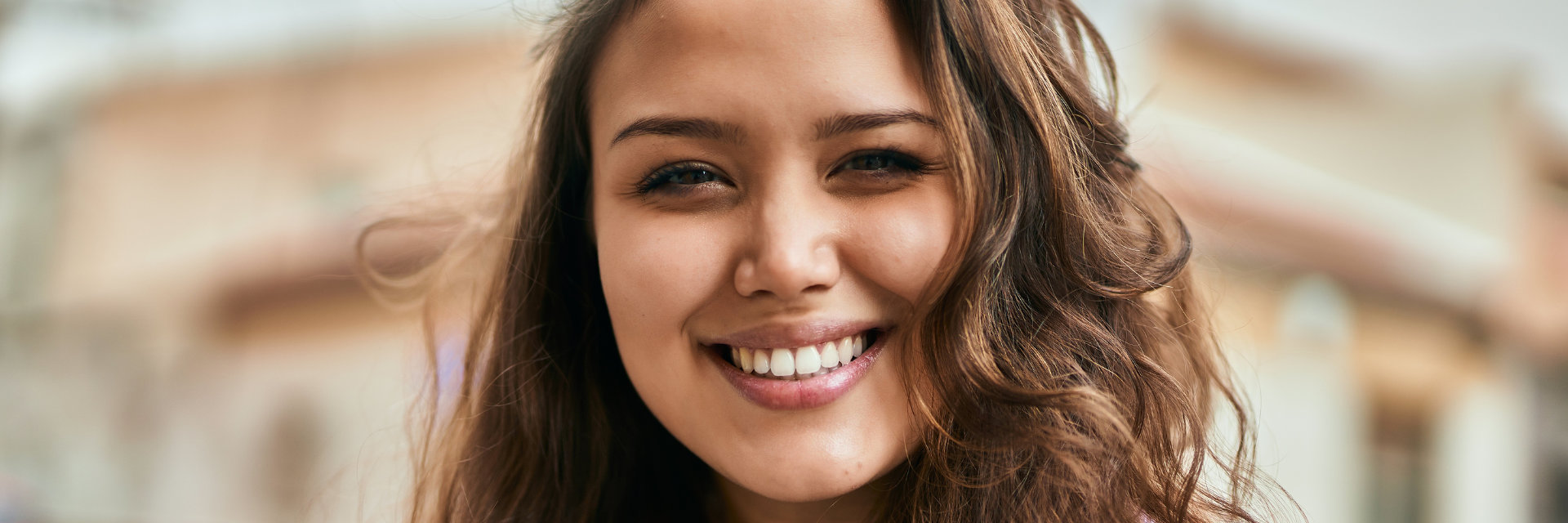 A beautiful young Hispanic woman with a perfect smile.